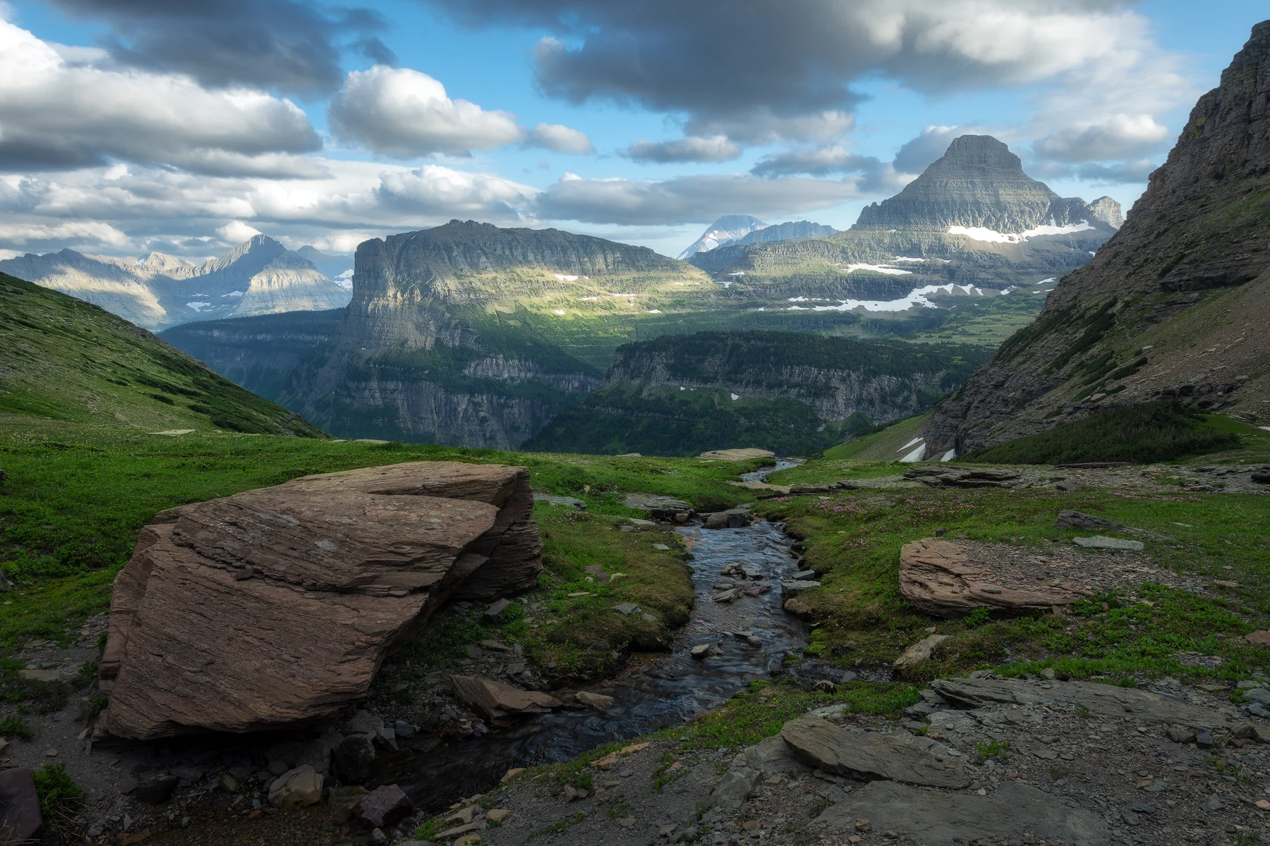 Lunch Creek flowing through a green valley below Mount Reynolds and neighboring peaks