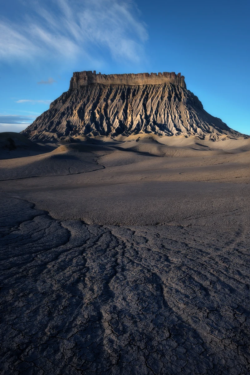 Factory Lines — Factory Butte rising above textured Utah Badlands