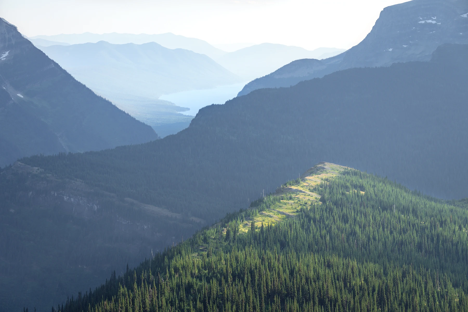 Misty mountains rise beneath an open sky.