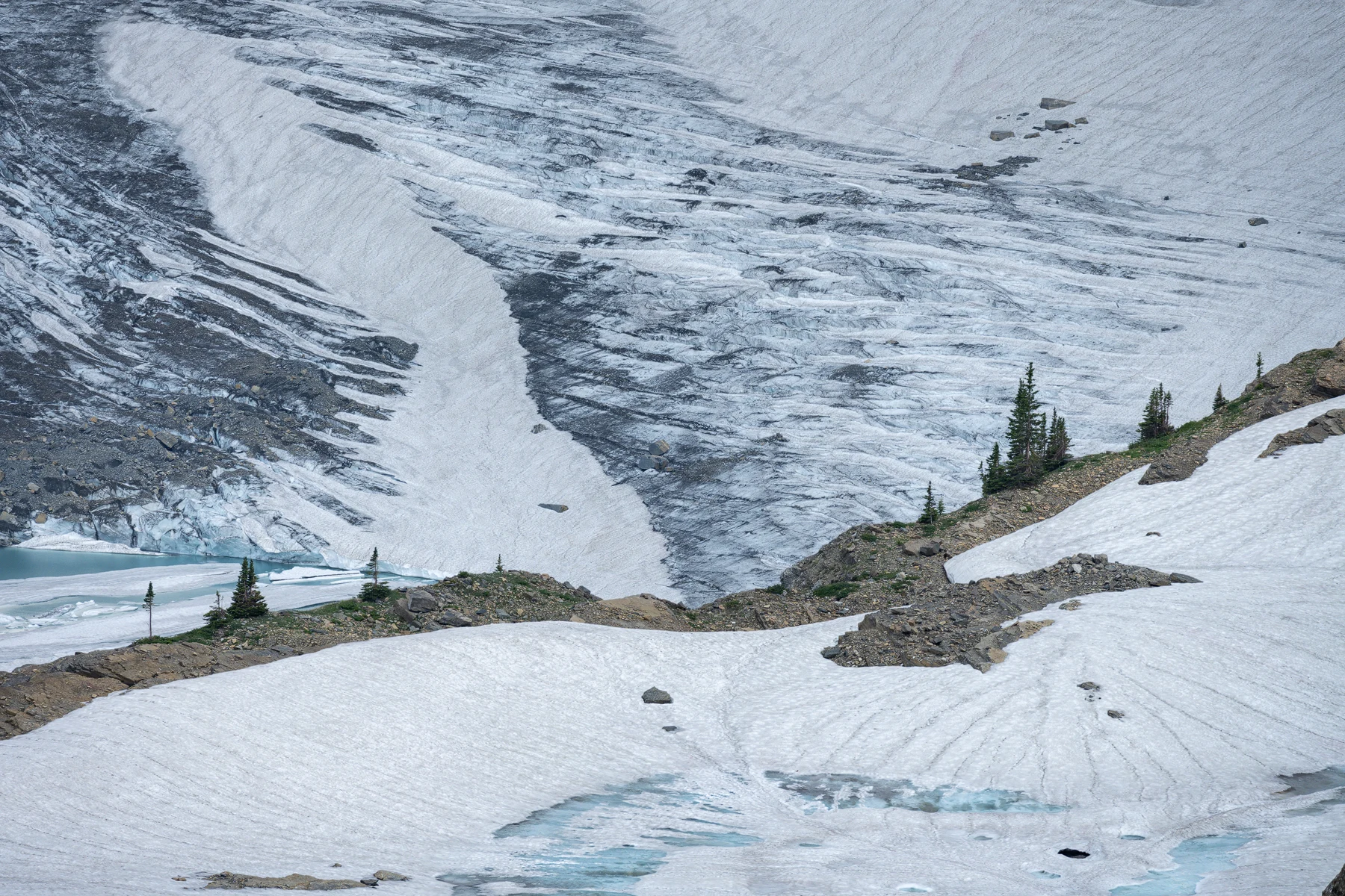 Snow-covered mountains rise beneath an open sky.