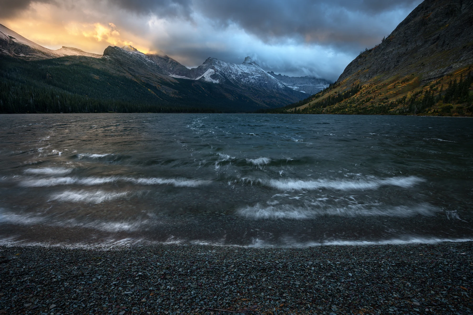 Cold front and golden dawn light above Elizabeth Lake in Glacier National Park