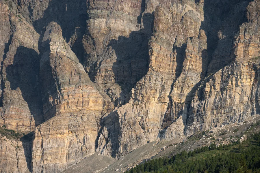 Layered rock cliffs in a canyon.