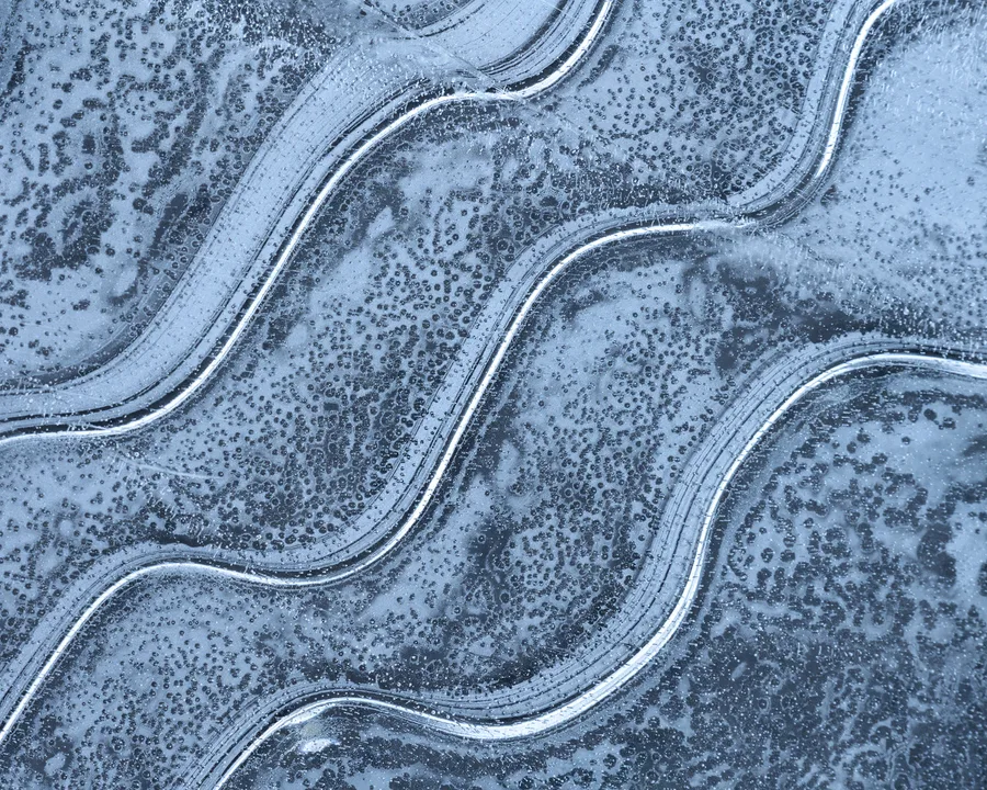 Abstract blue ice lines and frost patterns.