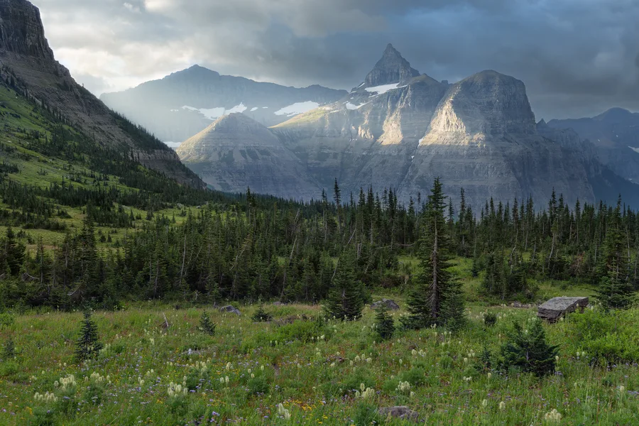 Snow-covered mountains rise beneath storm clouds.