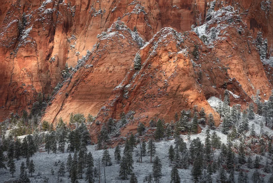 Orange sandstone cliff dusted with winter snow.