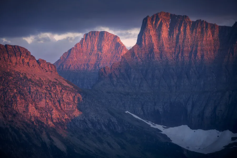 Snow-covered mountains rise beneath a cloudy sky.