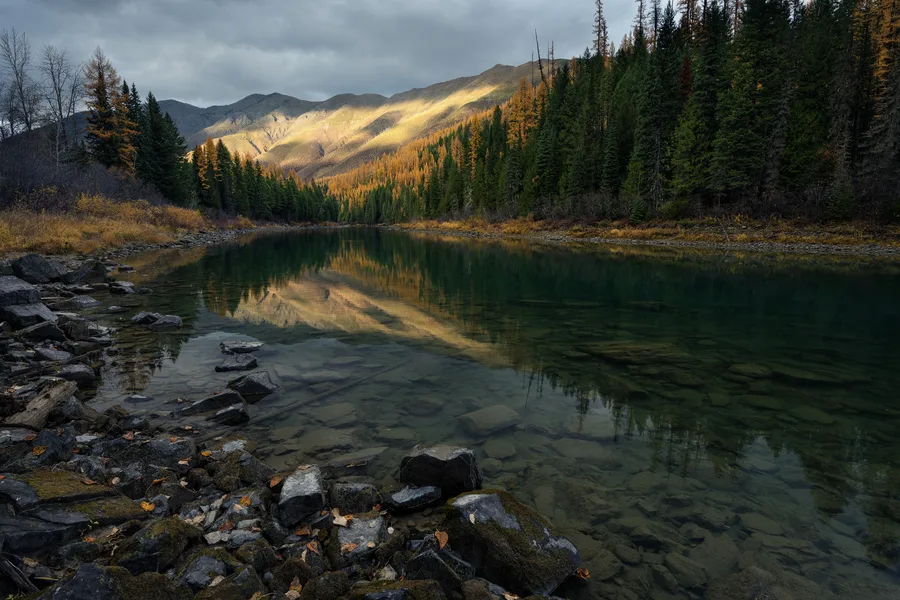 A mountain lake beneath cloud-filled skies.