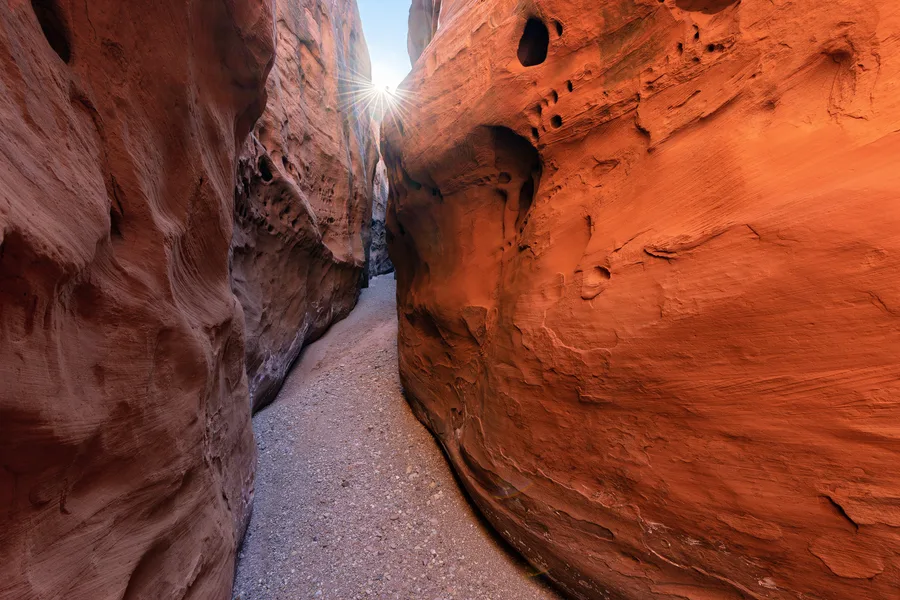 Layered sandstone cliffs in a canyon.