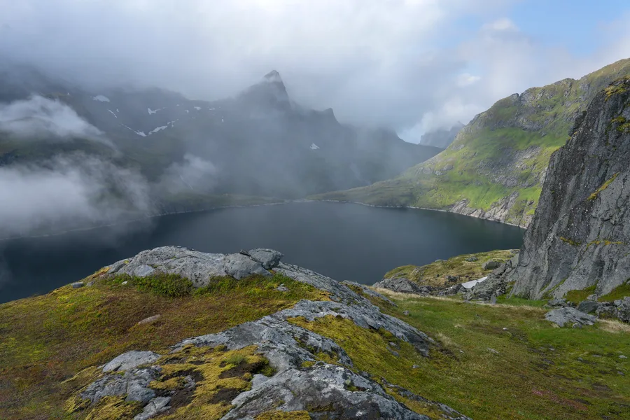 A clearing storm of fog and rain reveal colors, lakes, mountain peaks