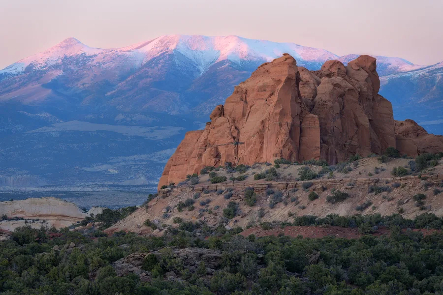 Snow-covered mountains rise beneath an open sky.