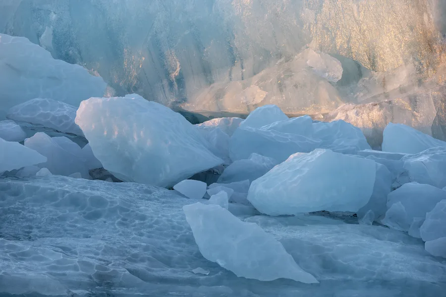 Blue glacier ice and water in soft Iceland light.