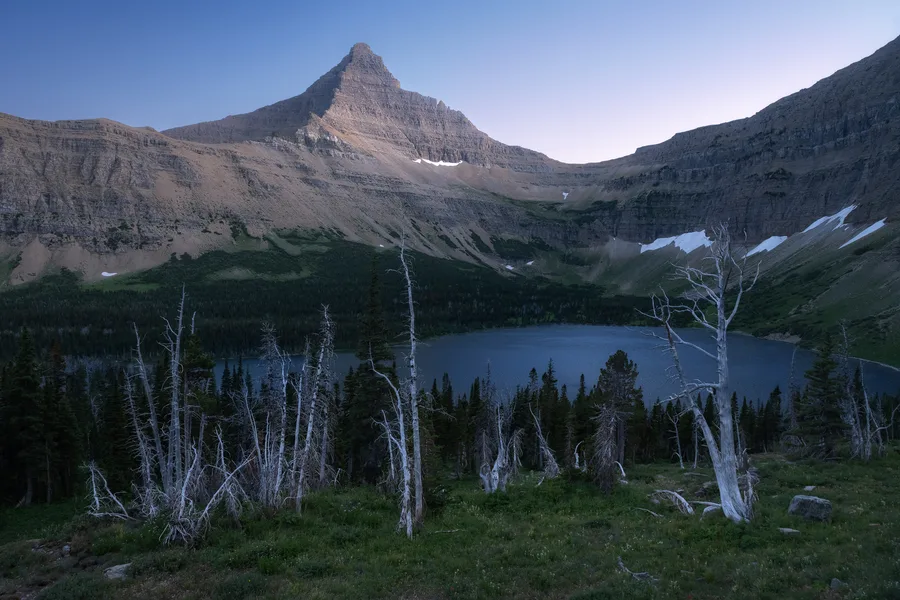 A mountain lake beneath snow-covered peaks.