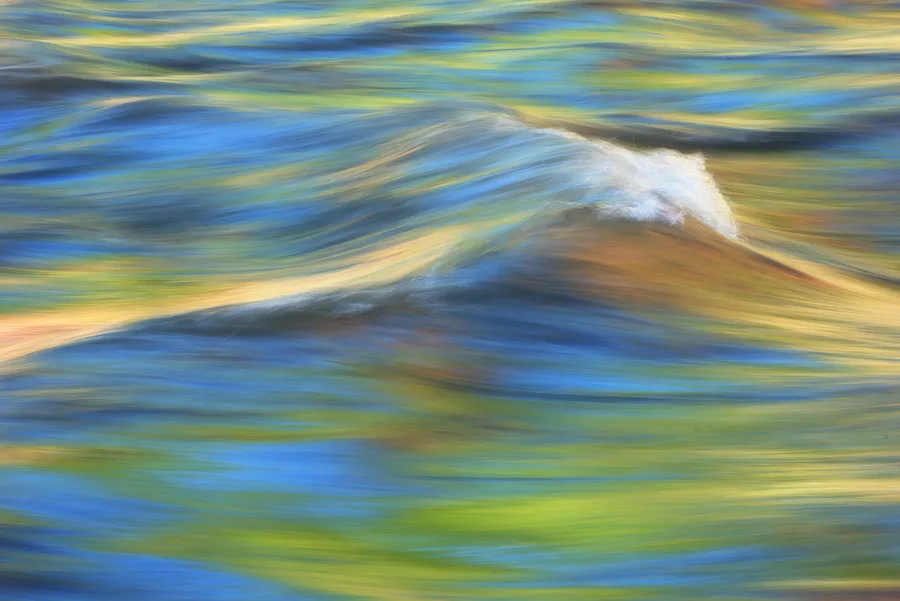 Blue and green river water flowing in soft abstract motion.