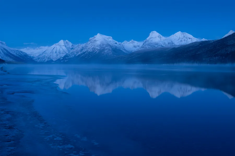 A mountain lake beneath snow-covered peaks.