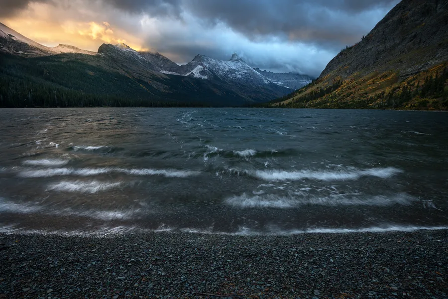 A mountain lake beneath snow-covered peaks.