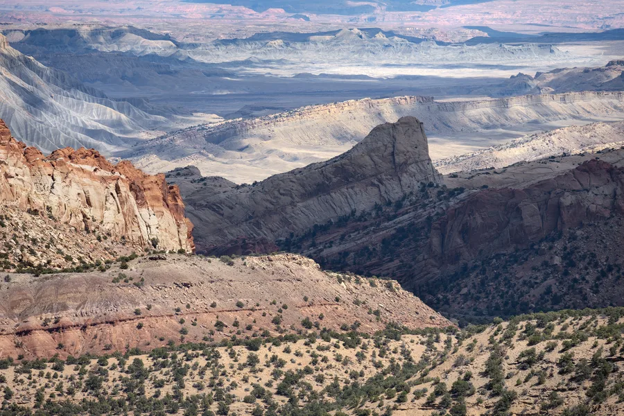 Layered sandstone cliffs in a canyon.